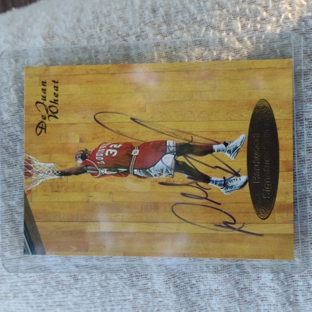 DeJuan Wheat autographed basketball card in protective cover.